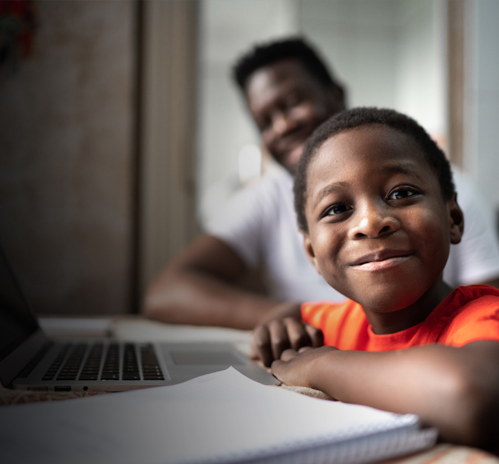 School age boy with laptop doing school work